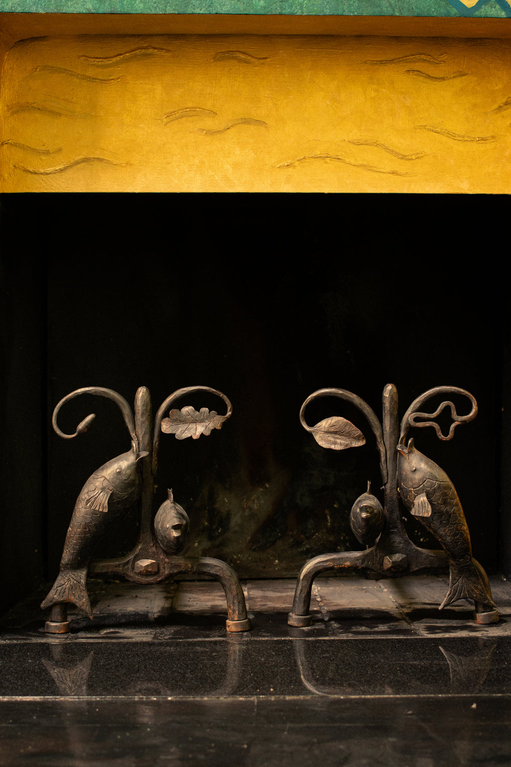 Andirons with oak leaves and fish, 1940