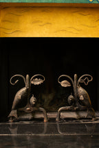Andirons with oak leaves and fish, 1940