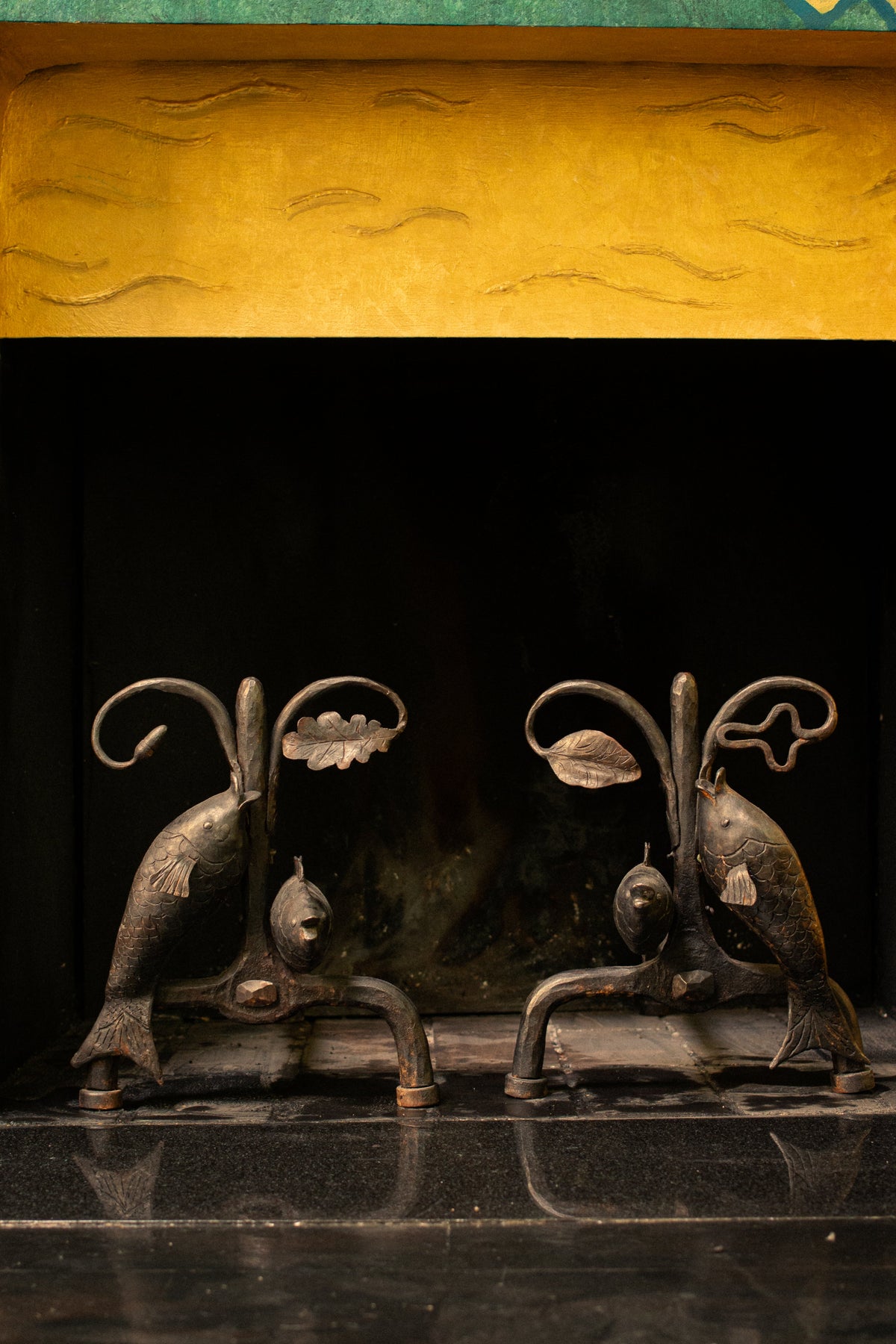 Andirons with oak leaves and fish, 1940